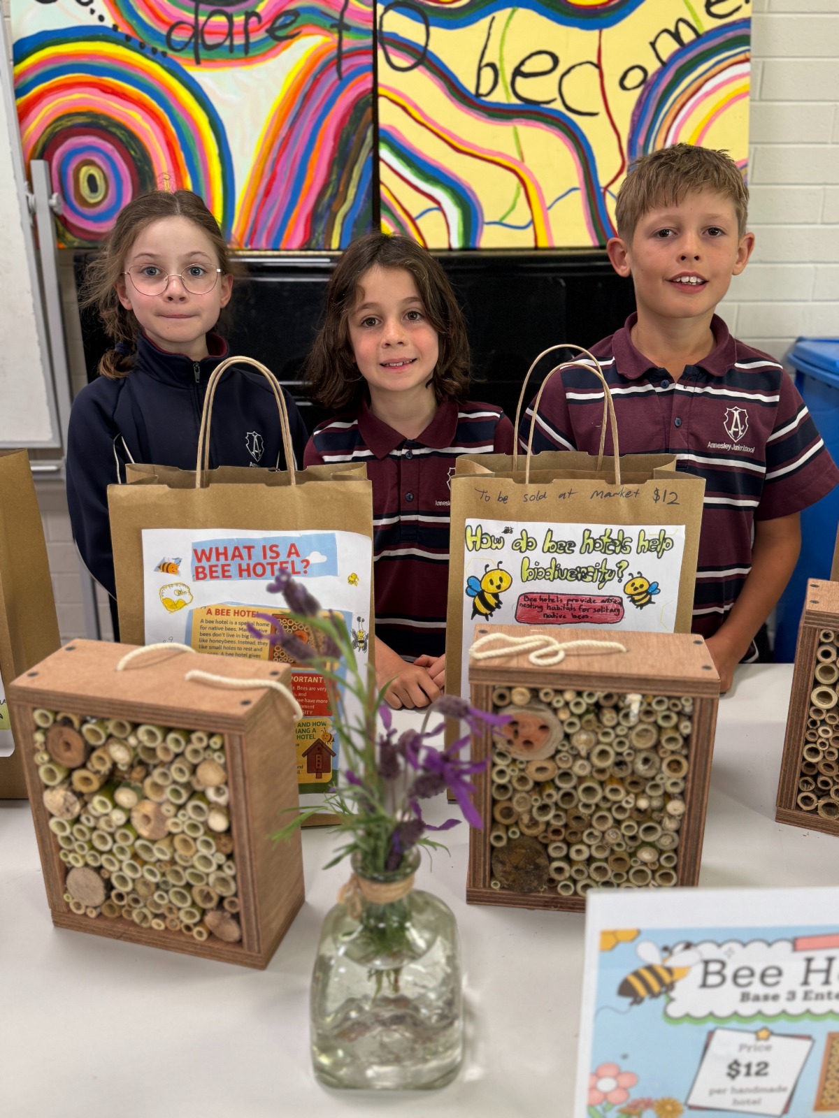 Year 4 students building native bee hotels from timber and bamboo on the school grounds